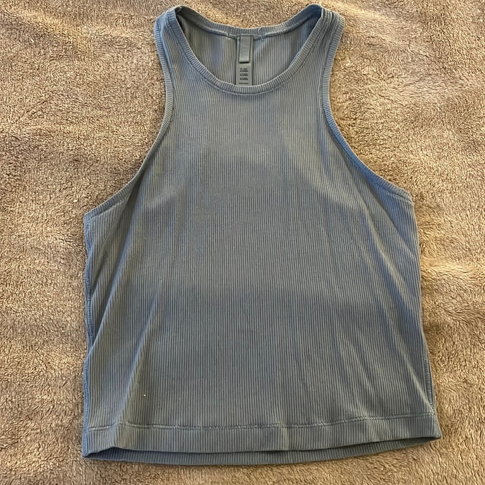 Skims light blue tank.